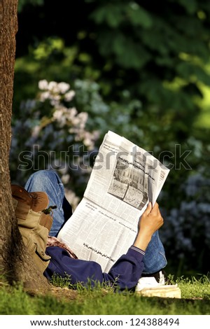 A citizen of the world find peace and information lying in the shade