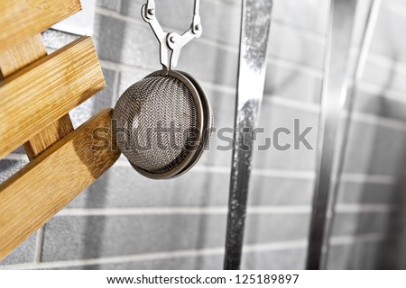 Kitchen tea filter on a grey tile marble wall
