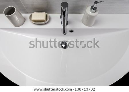 sink with soap dish and soap dispenser on his shelf