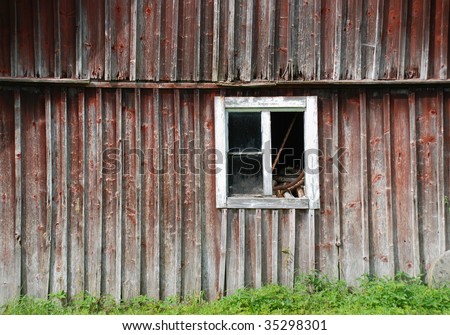 old weathered barn with a broken window