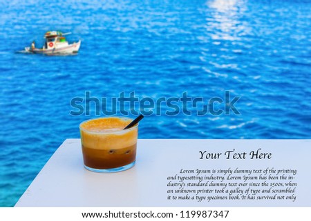 Coffee on table by the sea in Greek Island with wooden boat background and text