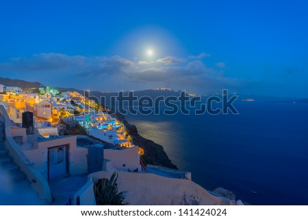 Greece Santorini island in Cyclades,  wide view of white washed colorful houses at night