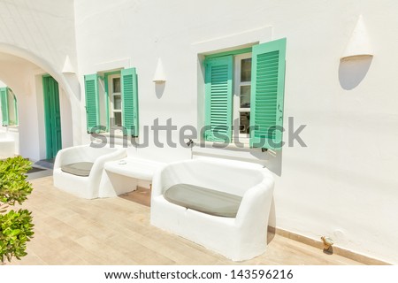 Greece Santorini island in Cyclades, traditional sights of colorful and white washed houses with wooden frames and flowers