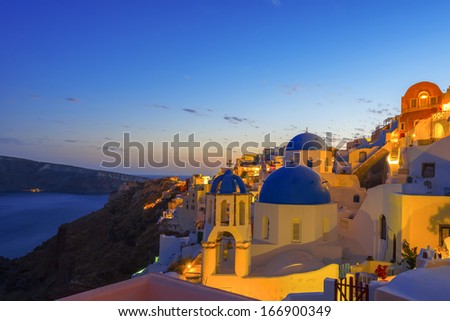 Dusk overlooking buildings on the Caldera at Oia Santorini Greece Europe at night with sea background