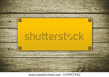 Yellow sign on wooden background