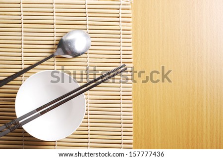 Asian dish place setting on bamboo mat, Korean style