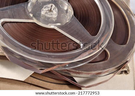 Old vintage bobbins with magnetic tapes close up