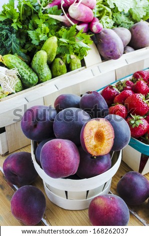 Assortment of fruits and vegetables in the baskets. Black Apricots - hybrid apricot and cherry-plum