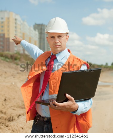 Portrait of builder works at construction site