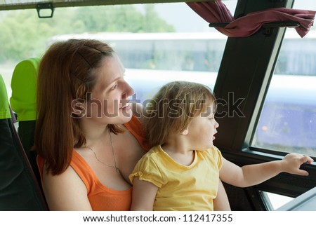 Mother and child looks to window in autobus