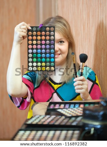 Female stylist with cosmetics ready for job