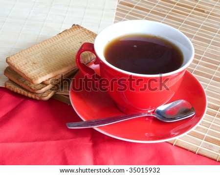 red cap of tea and cookie on cook-table