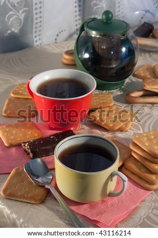 caps of tea and cookie on cook-table