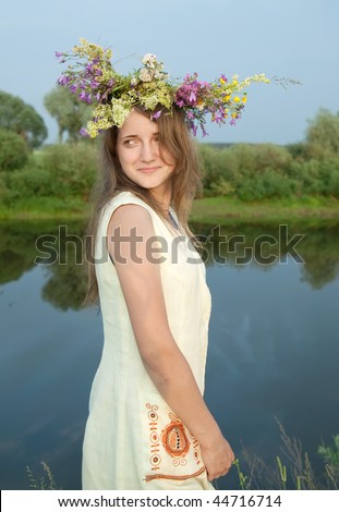 girl  in russian traditional clothes against river