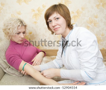 Doctor giving a girl an intravenous injection in her arm