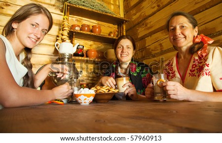 Women near  traditional russian samovar in russian traditional interior