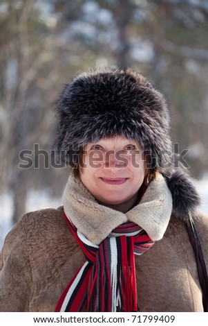mature woman  wearing winter coat and fur  cap
