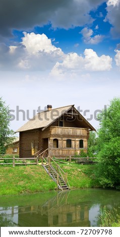 Wooden country house on the lake in summer