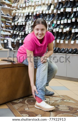 Woman trying shoes  for size  at shoes shop