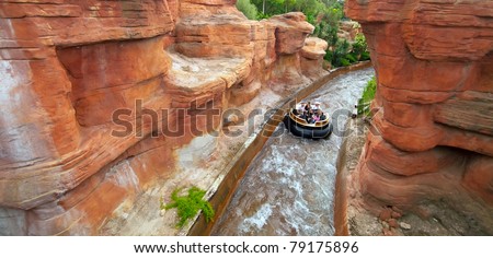 SALOU, SPAIN - APRIL 13: People ride in Theme Park in April 13, 2011 in Salou, Spain. Grand Canyon Rapids  is one of the rides in Old American West area at Port Aventura