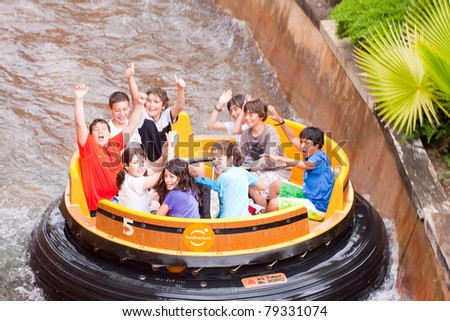 SALOU, SPAIN - APRIL 13: People ride at Theme Park in April 13, 2011 in Salou, Spain.  Grand Canyon Rapids is one of most exhilarating rides in Old American West area at Port Aventura