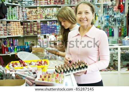 Two women chooses cosmetic at cosmetics  shop
