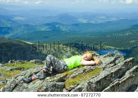 Female tourist resting at mountain peak
