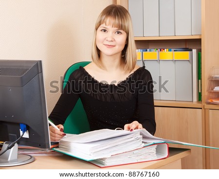 Blonde businesswoman with documents  working in office room