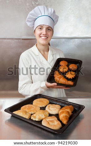 Baker with fresh pastries at bakery