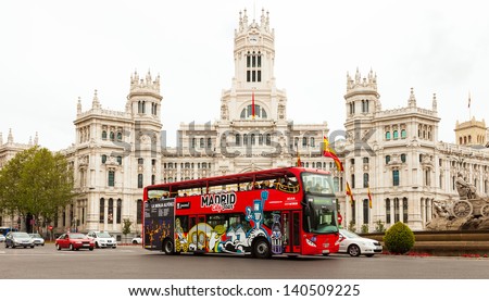 MADRID, SPAIN - APRIL 26: Touristic bus against Palace of Communication in April 26, 2013 in Madrid, Spain. Palace of Communication, since 2011 named Cibeles Palace (Palacio de Cibeles)