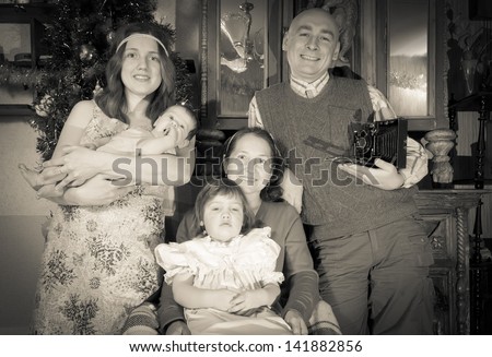 Imitation of vintage photo of Christmas portrait of happy family of photographer
