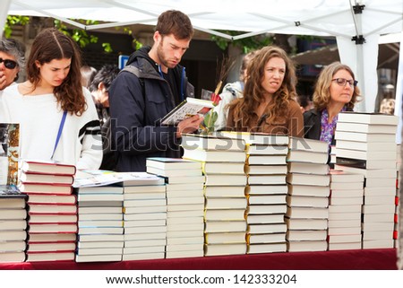 BARCELONA, CATALONIA - APRIL 23: Books on stalls in Saint George day. in April 23, 2013 in Barcelona, Catalonia. Saint George is the patron saint of city. Focus on books