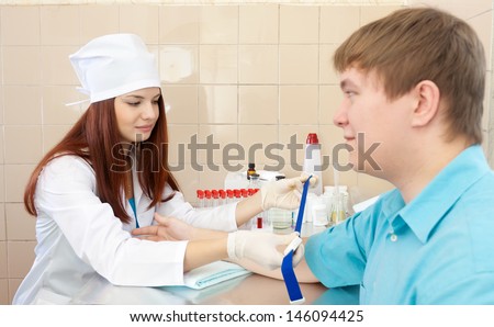 nurse prepares to make an intravenous injection. Focus on man