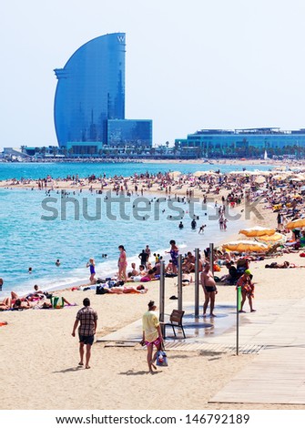 BARCELONA, SPAIN - JUNE 28: Barceloneta Beach and Hotel Vela in summer in June 28, 2013 in Barcelona, Spain.  Barceloneta Beach - one of the most popular in the city