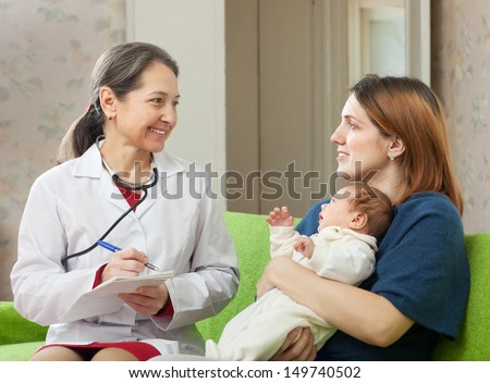 friendly mature pediatrician doctor of prescribes to newborn baby the medication at home
