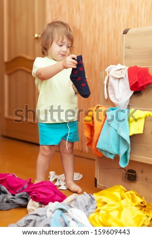 Baby girl  chooses dress in parent\'s closet