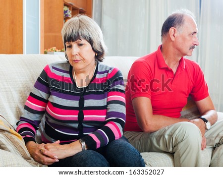 Senior couple after quarrel in living room