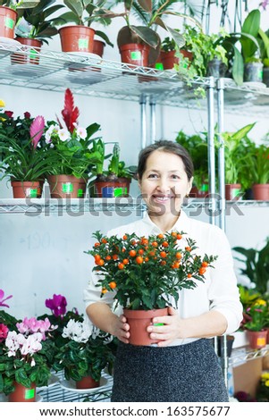 Female florist with Calamondin at flower store
