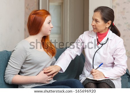 patient complaining  to doctor about  abdominal pain at  hospital