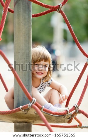 child  on ropes at playground area