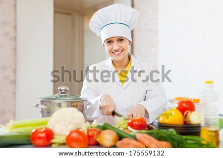 cook woman cooking vegetarian lunch  at commercial kitchen