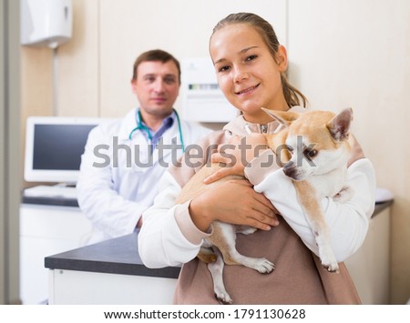 Happy teen girl led dog for examination by a veterinarian Stock fotó © 