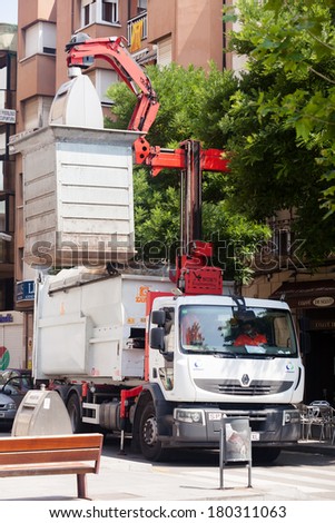 BARCELONA, SPAIN - JUNE 23: Garbage truck collects garbage dumpster in June 23, 2013 in Barcelona, Spain.   Recycling truck picking up bin