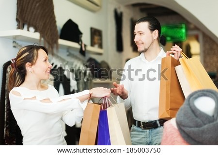 Man and woman with shopping bags at clothing boutique