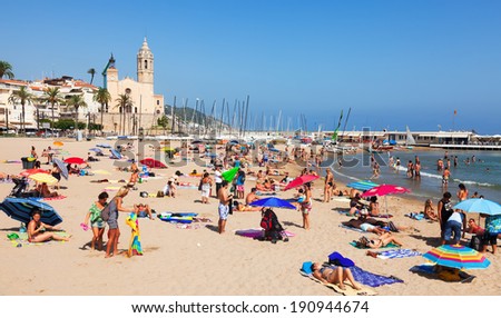 SITGES, SPAIN - AUGUST 6: Summer view of Mediterranean  beach in August 6, 2013 in Sitges, Spain.  Town is known for its sandy  coast