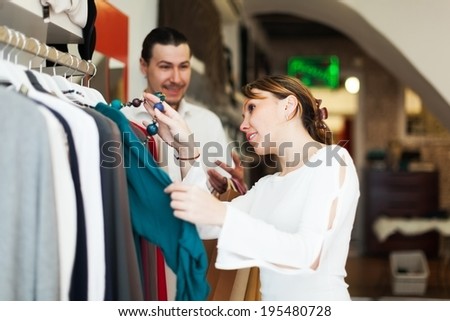 couple choosing clothes at fashion boutique together