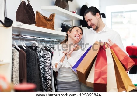 Couple choosing clothes at fashion market together