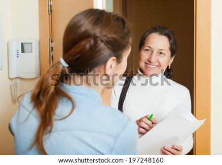 Mature woman polling among the population at door