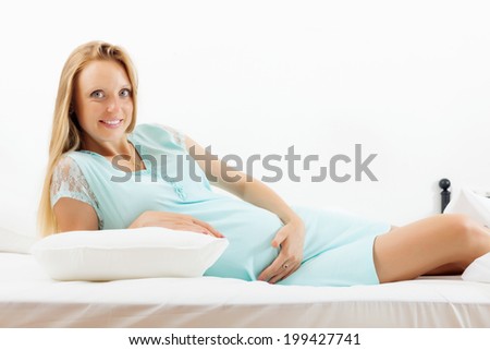 long-haired pregnancy woman  in bedroom