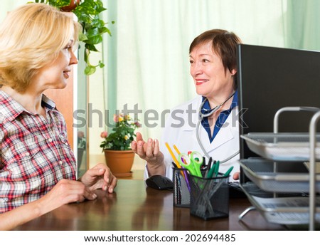 Mature woman on reception at the friendly woman doctor
